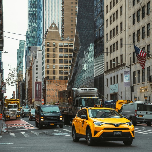 Cars driving in NYC streets.