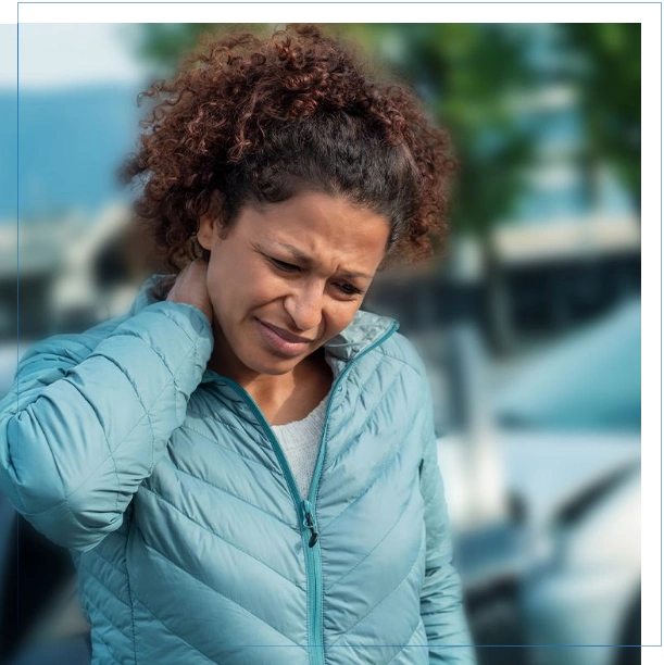 DEDICATED-TO-WINNING Woman outside holding neck in pain