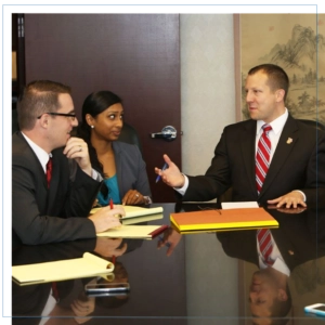 Ethan Irwin talking with team and client.